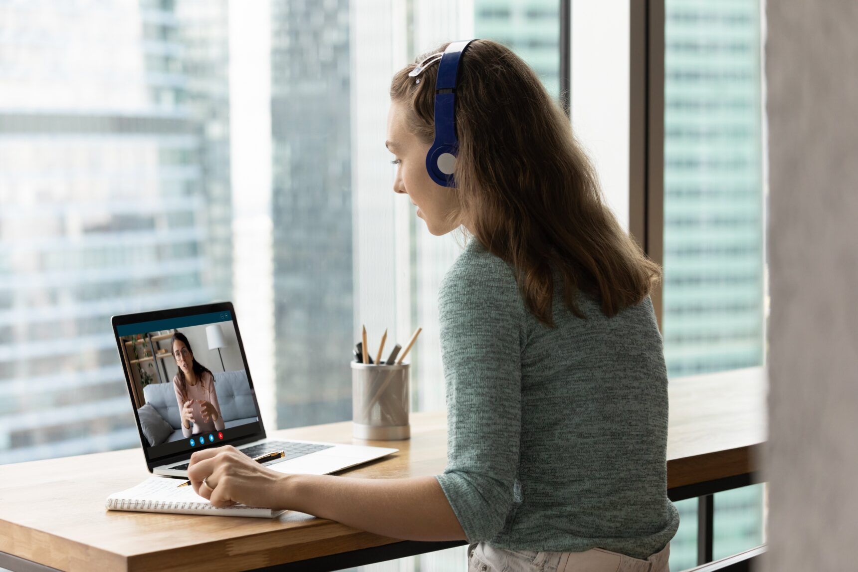 Female student chatting to her online tutor.