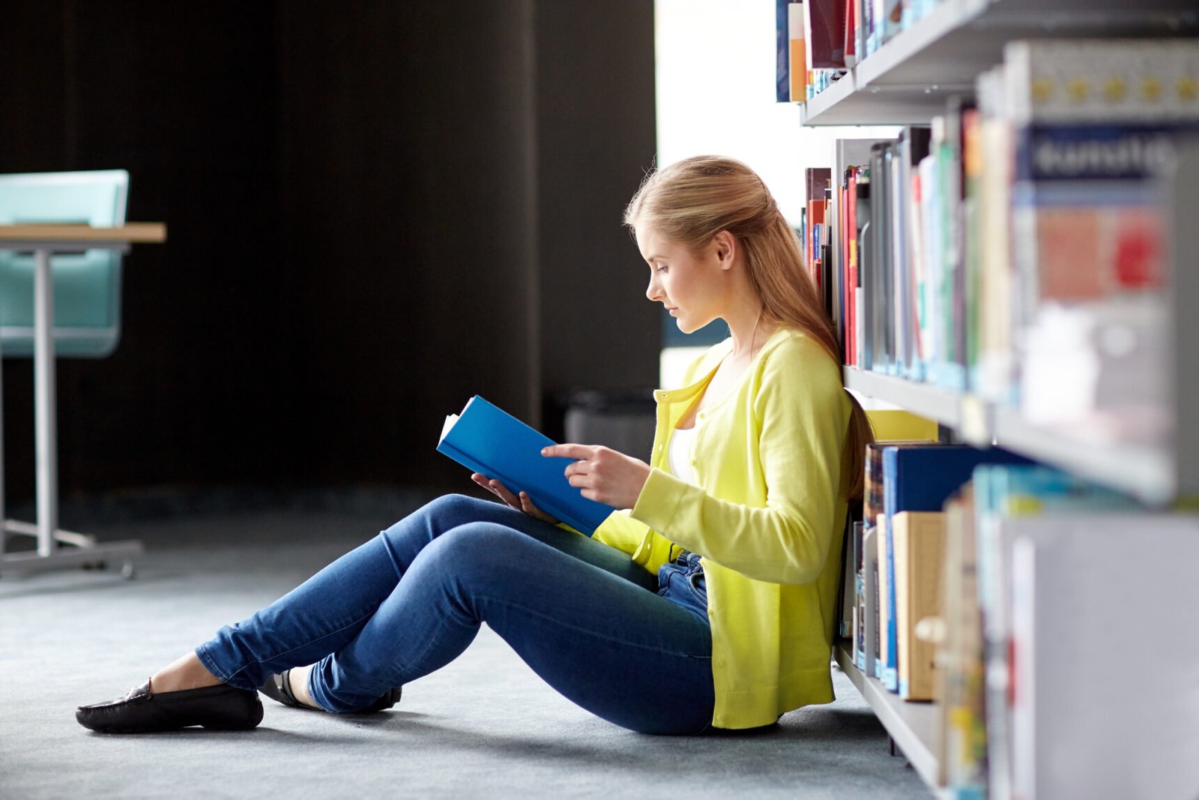 Student reading a Geography book for her NEA literature review.