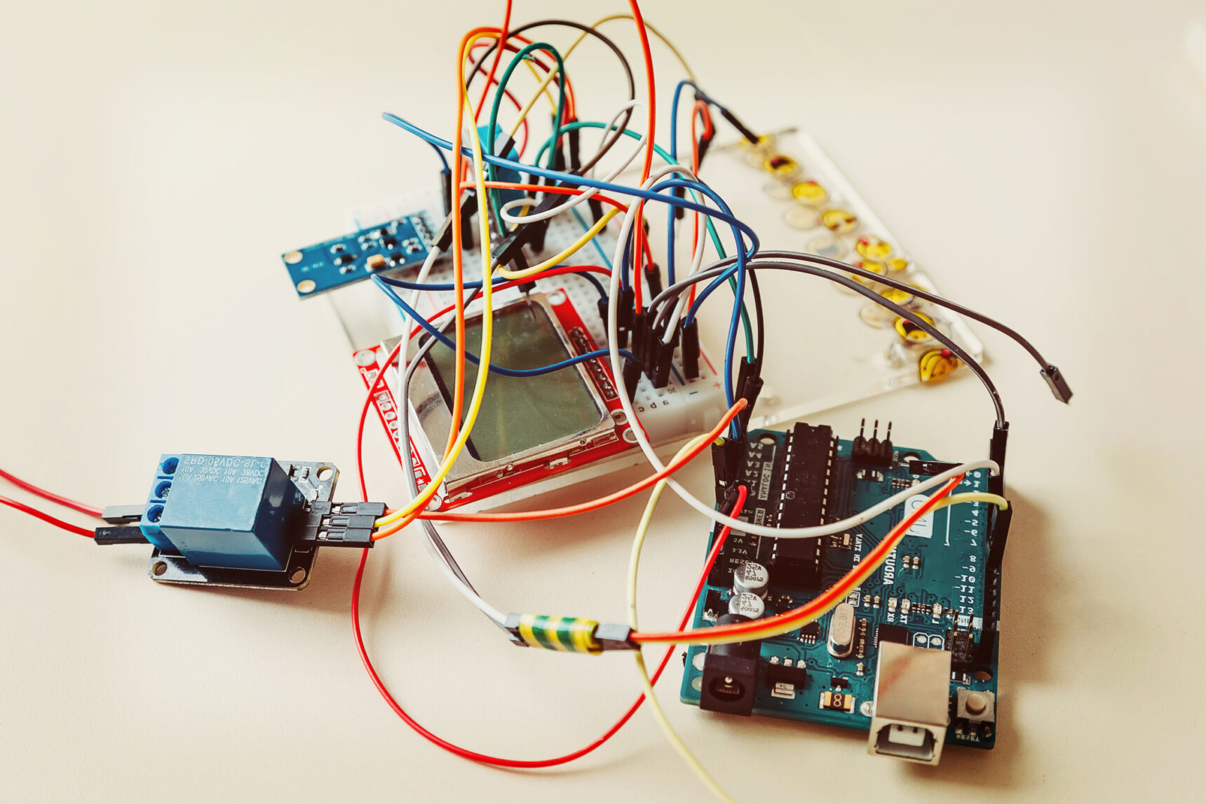 A student's electronics project containing a circuit board and lots of wires for a competition.