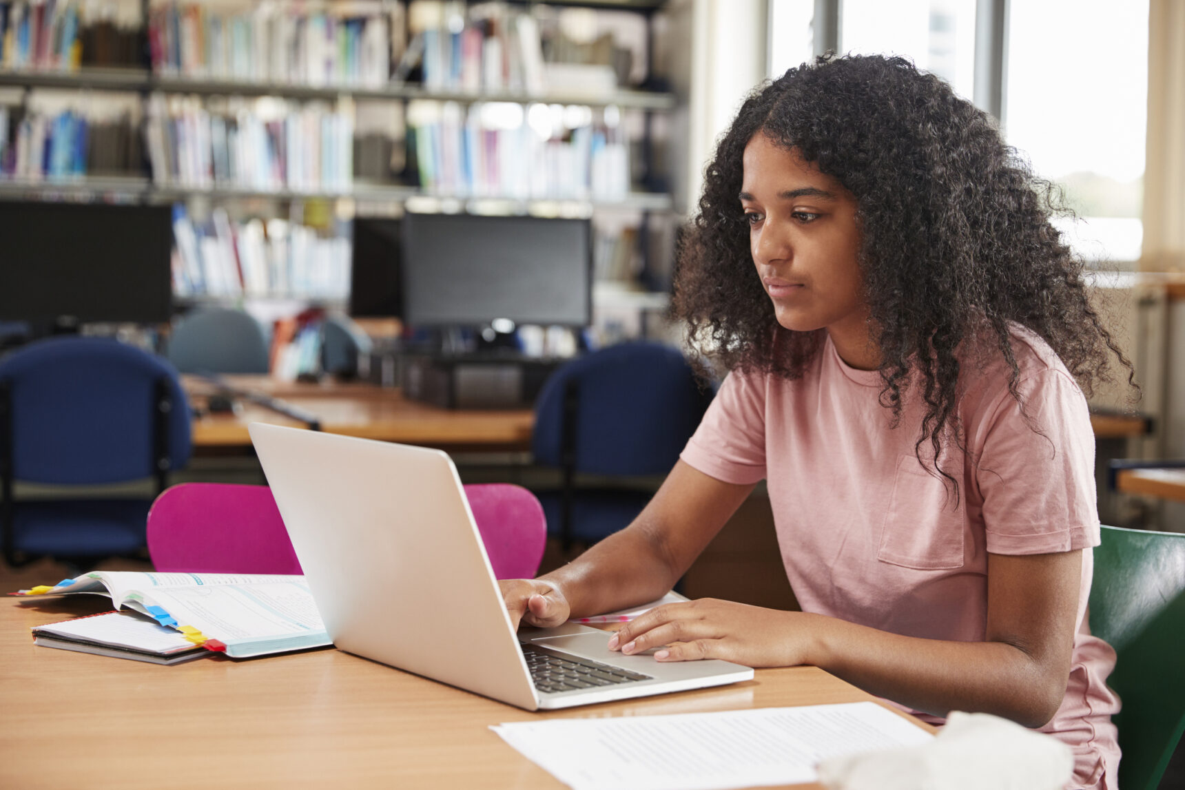 Female student studying technology on laptop.