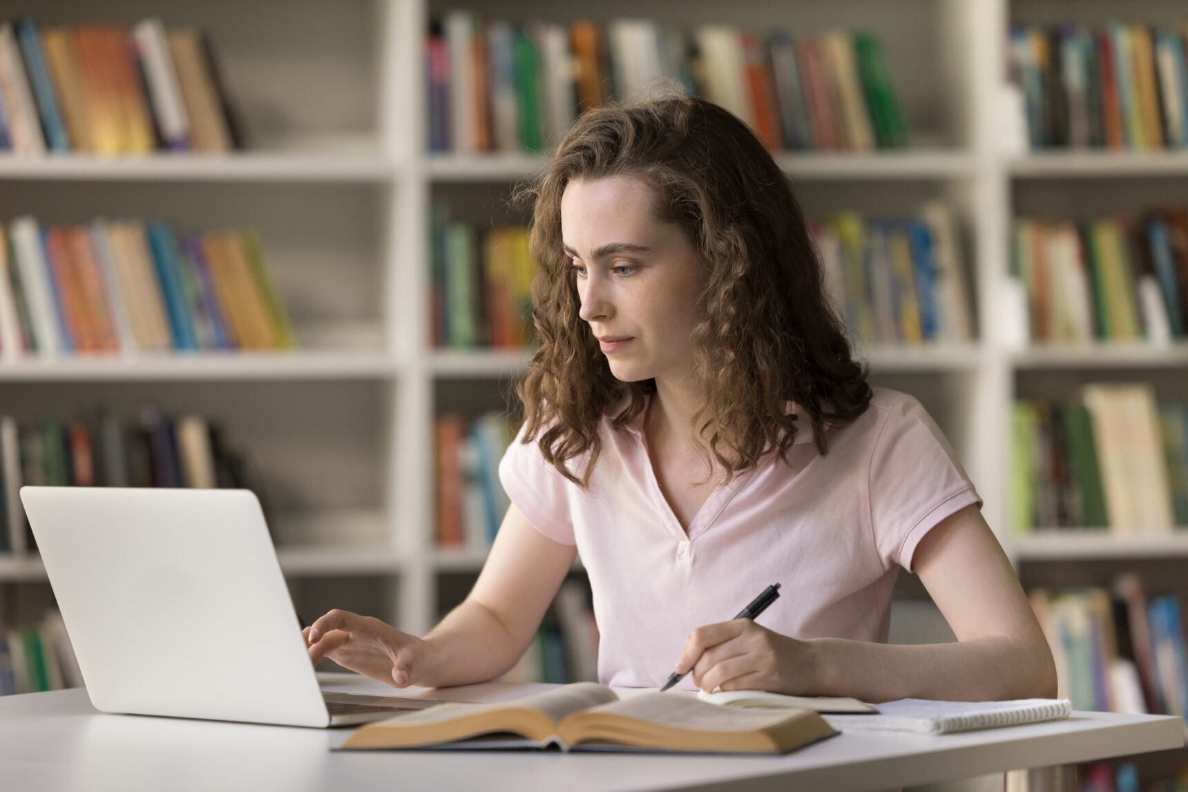 Female student completing their IB DP extended essay.