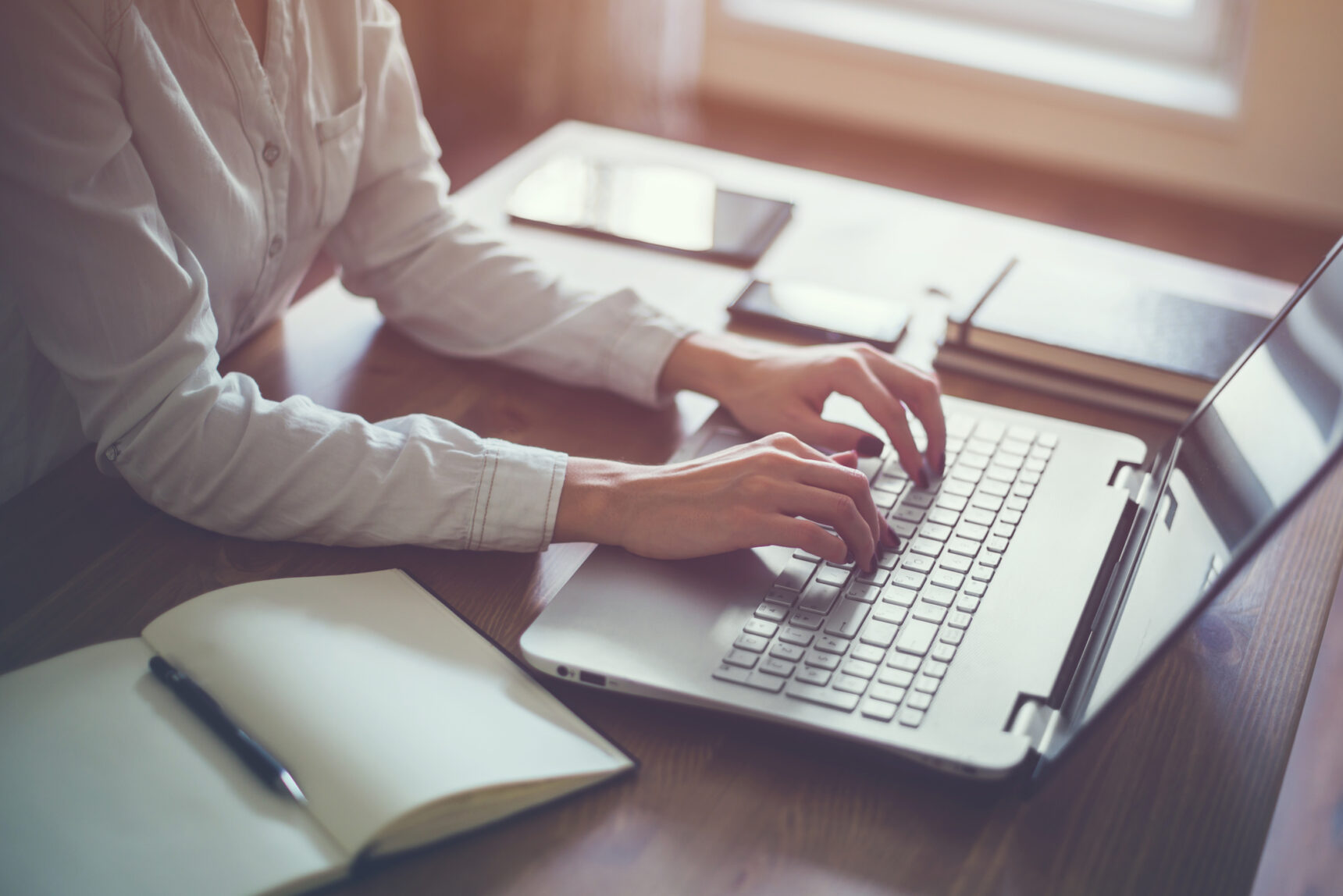 Female student completing her university application on a laptop