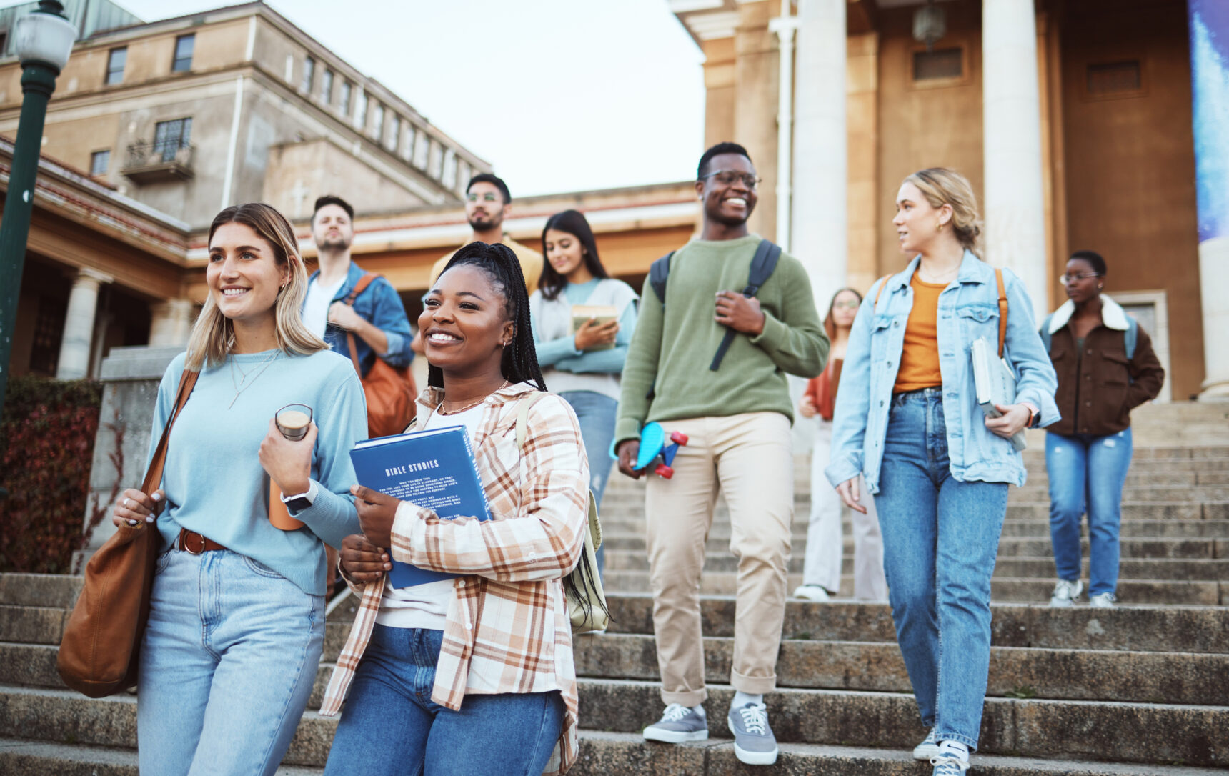 Oxbridge University students walking down steps.