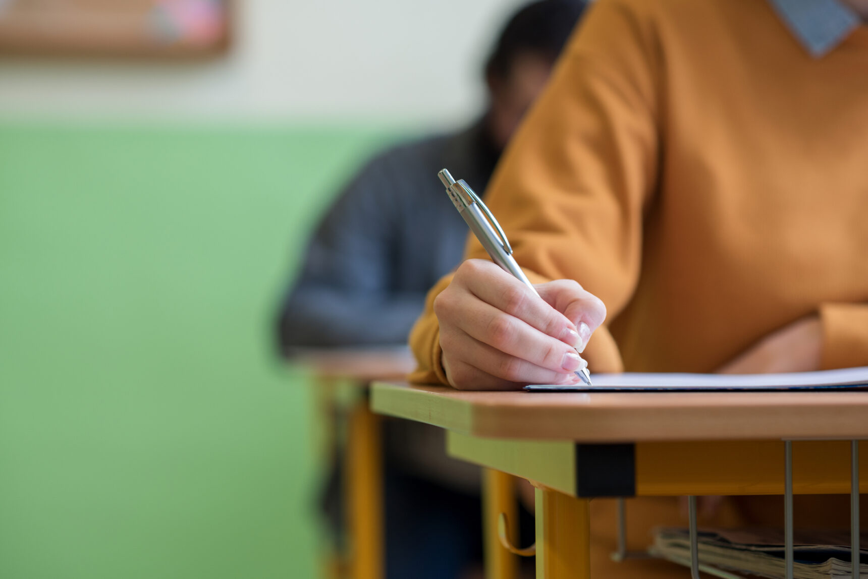 Student taking an admissions exam in an exam room