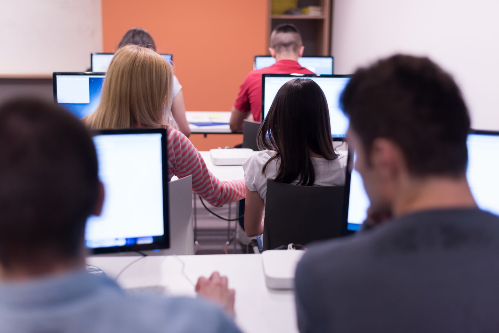 T Level students working on digital skills in a computer classroom.