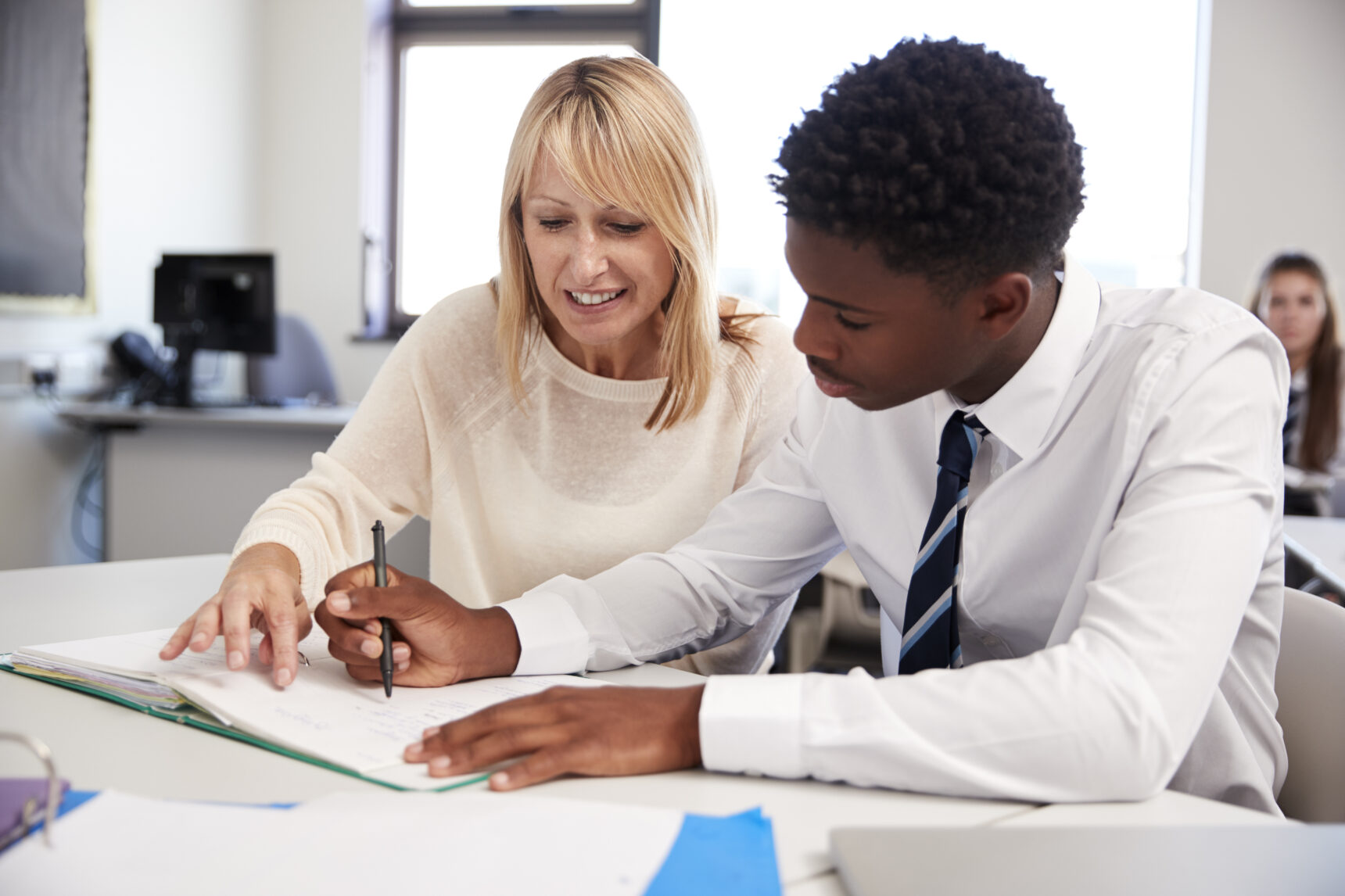 Teacher providing one-to-one support to SEND pupil.