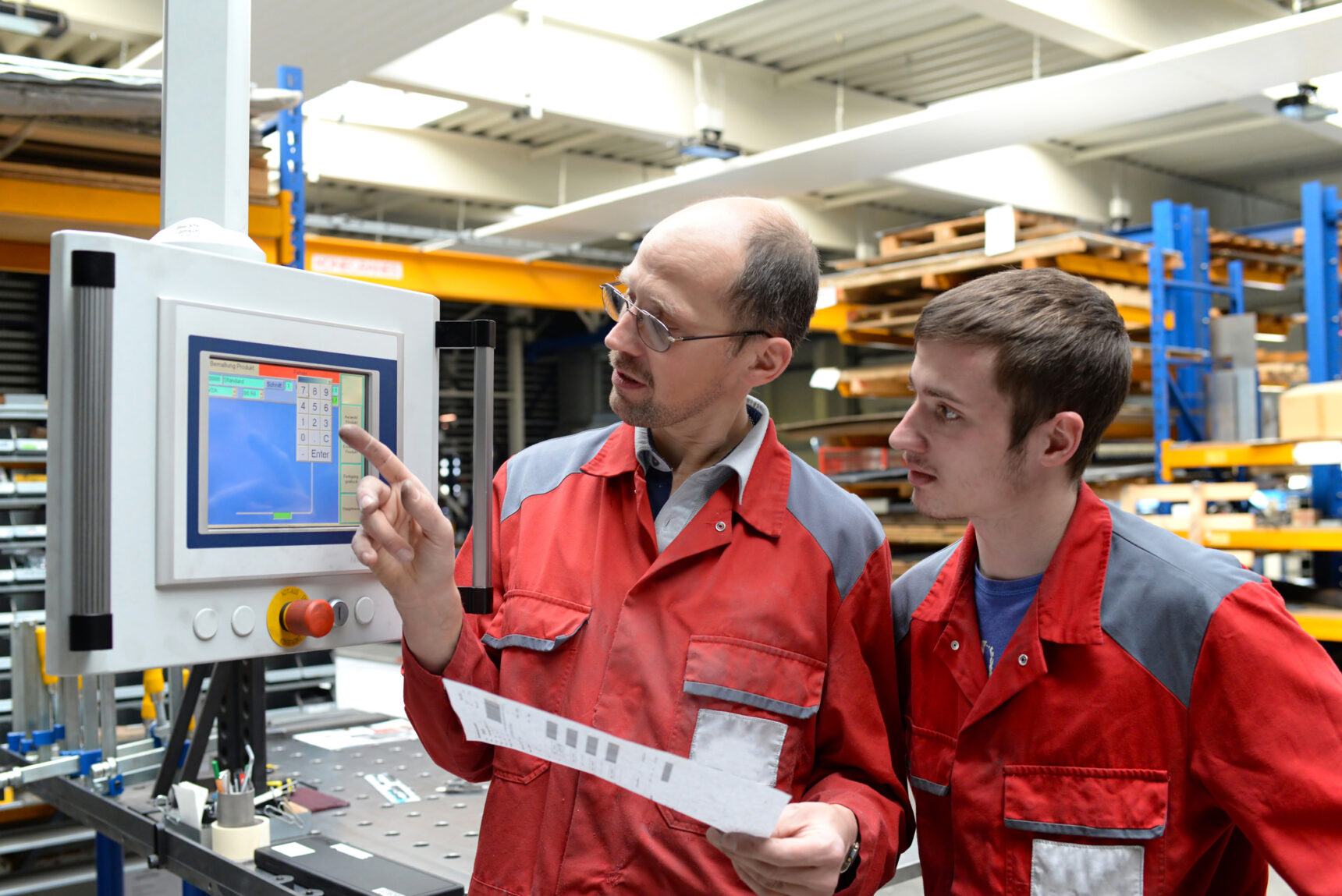 Student apprentice being taught how to use a specialist piece of equipment.