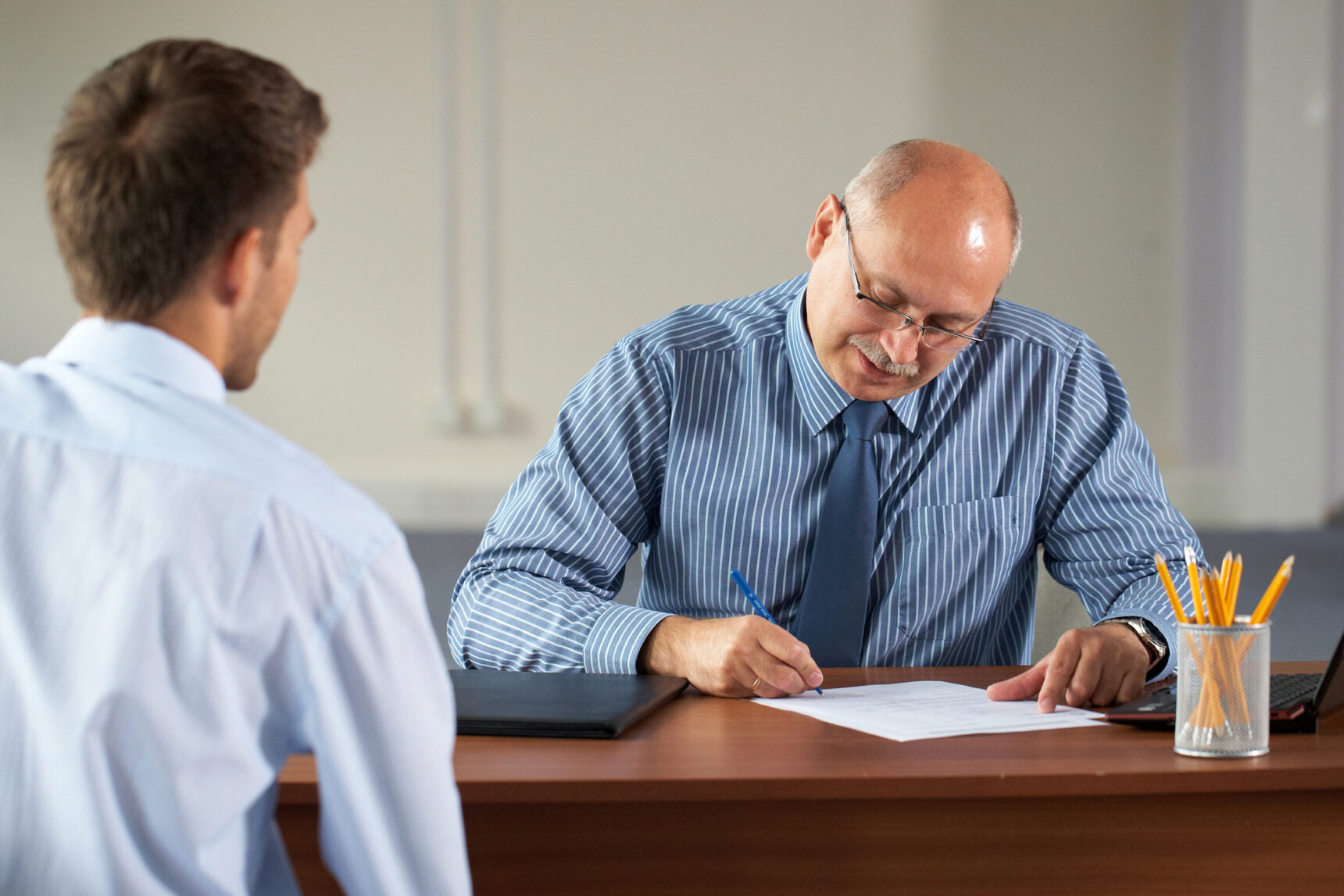 Job interview with a senior manager and young degree apprentice.