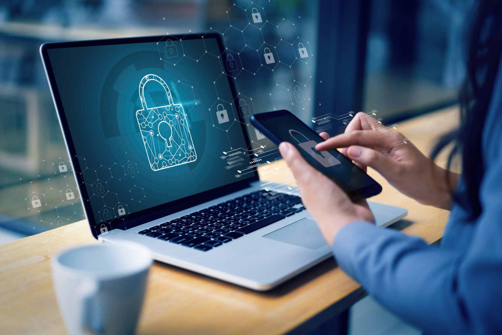 Laptop and phone displaying a padlock symbolising cyber security