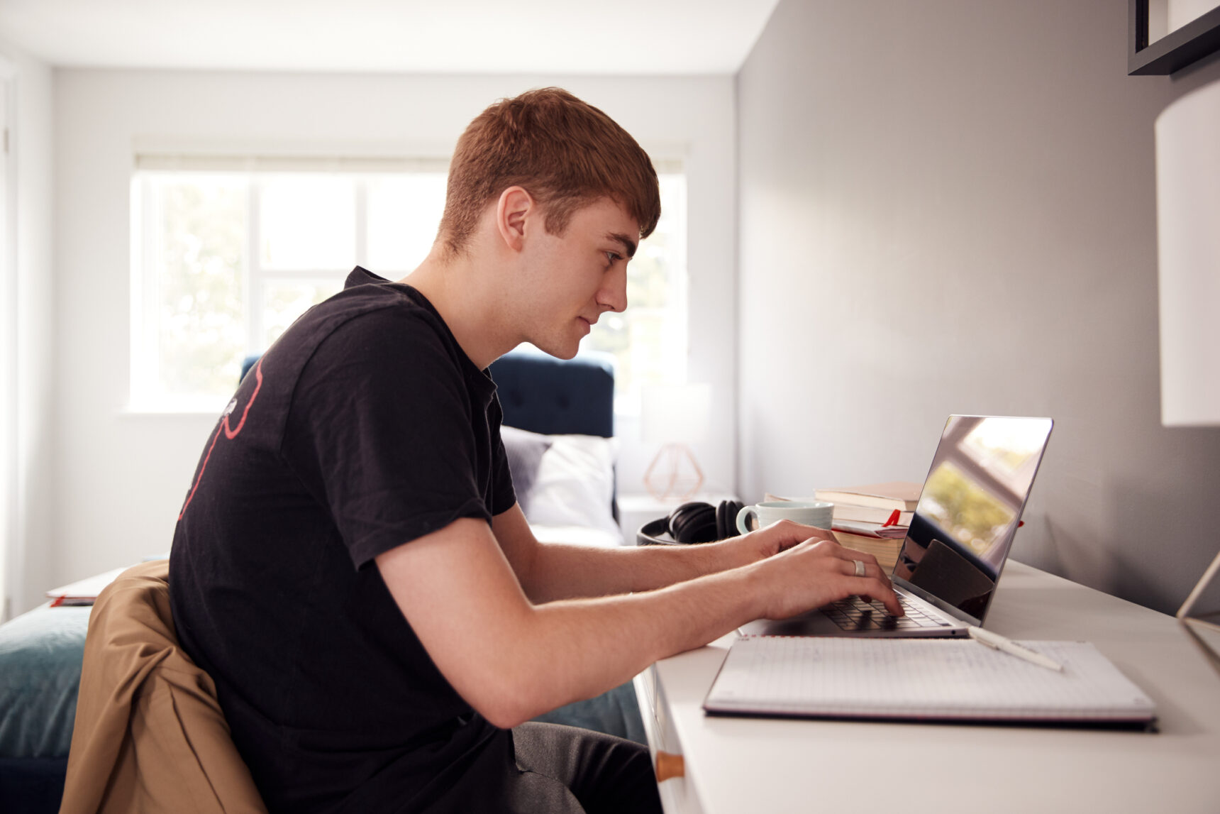 Male university student researching STEM master's degree courses.