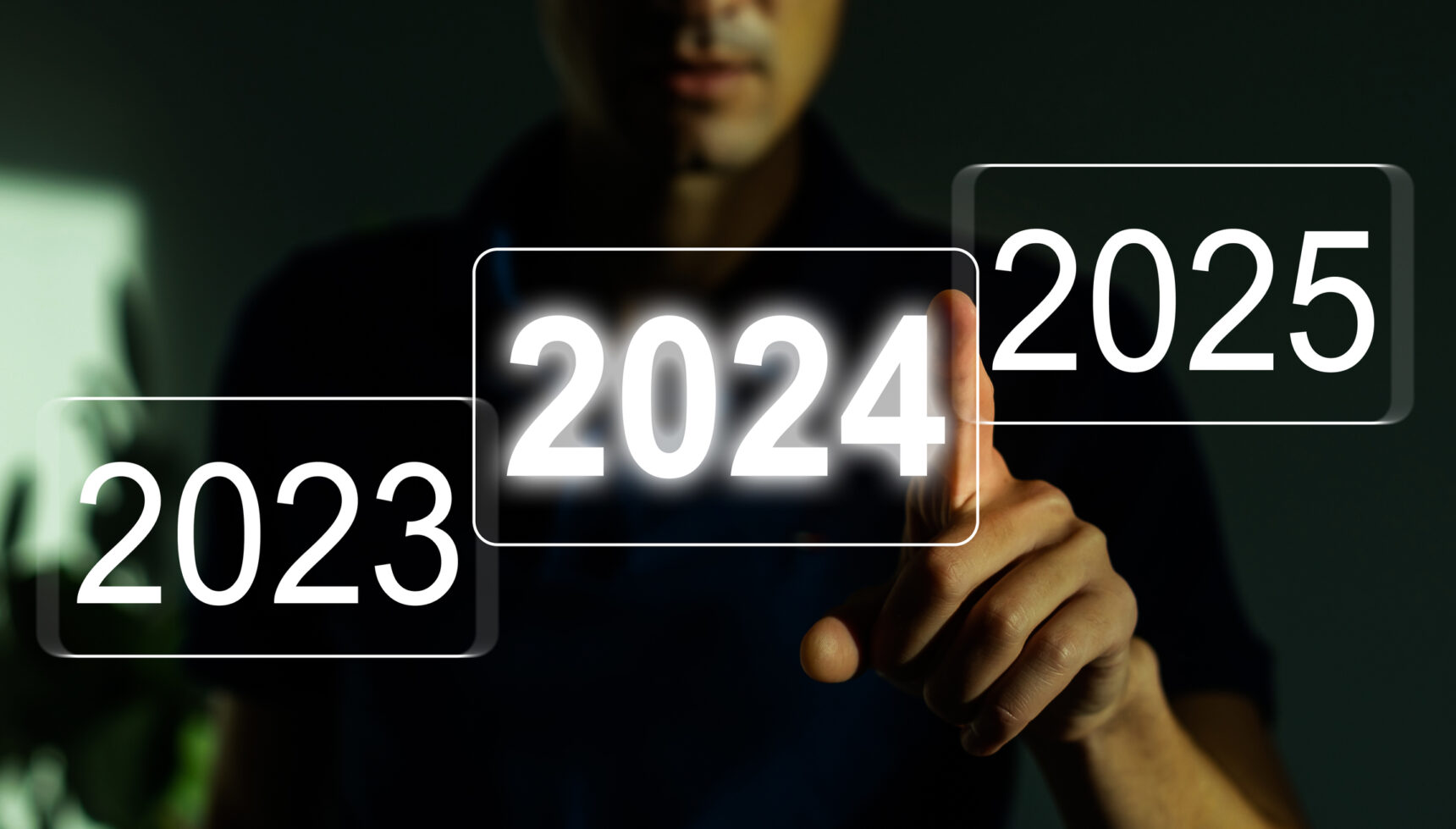 Man choosing between 2023, 2024, and 2025 on an interactive screen.