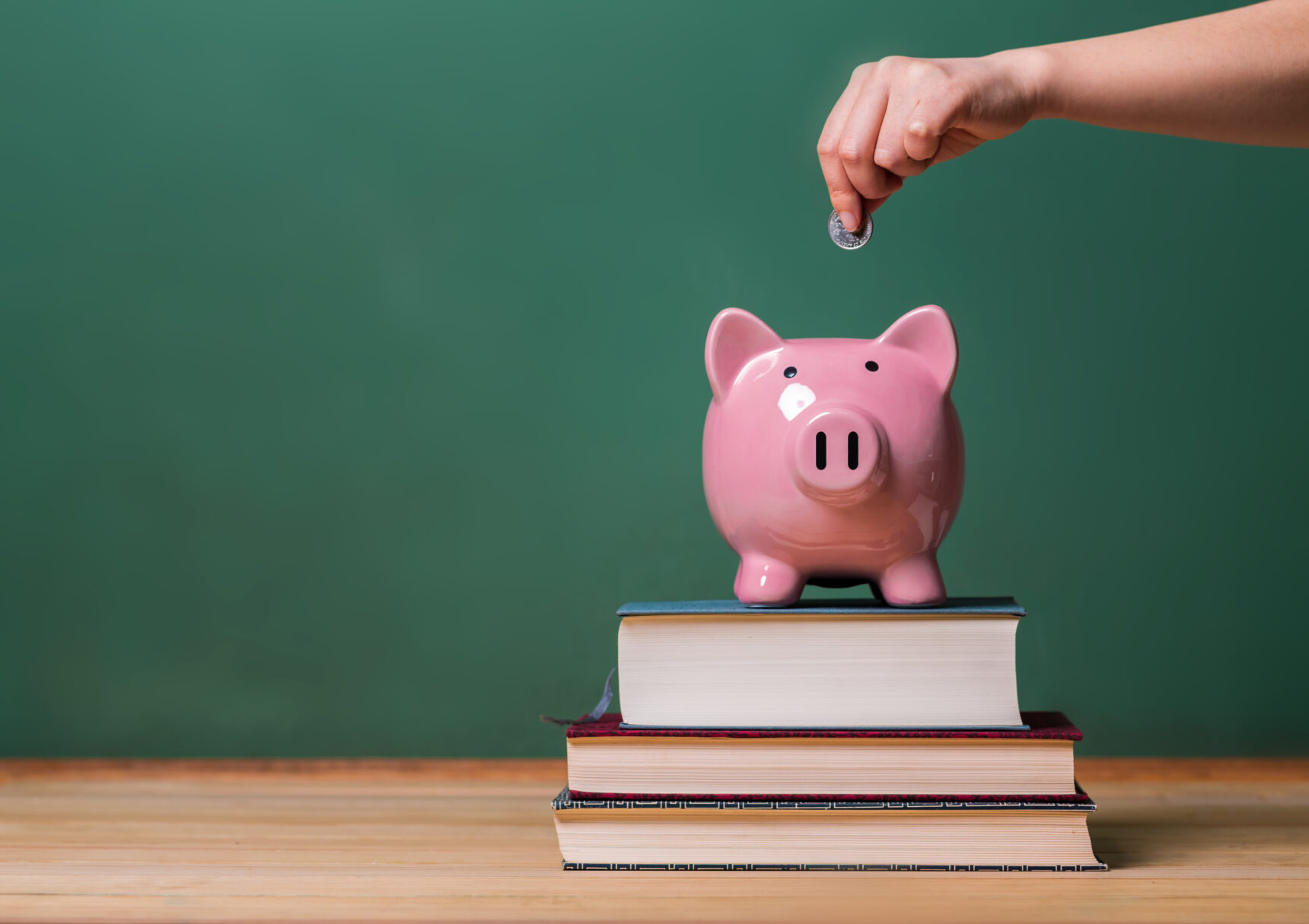 Piggy bank, books, and coin.