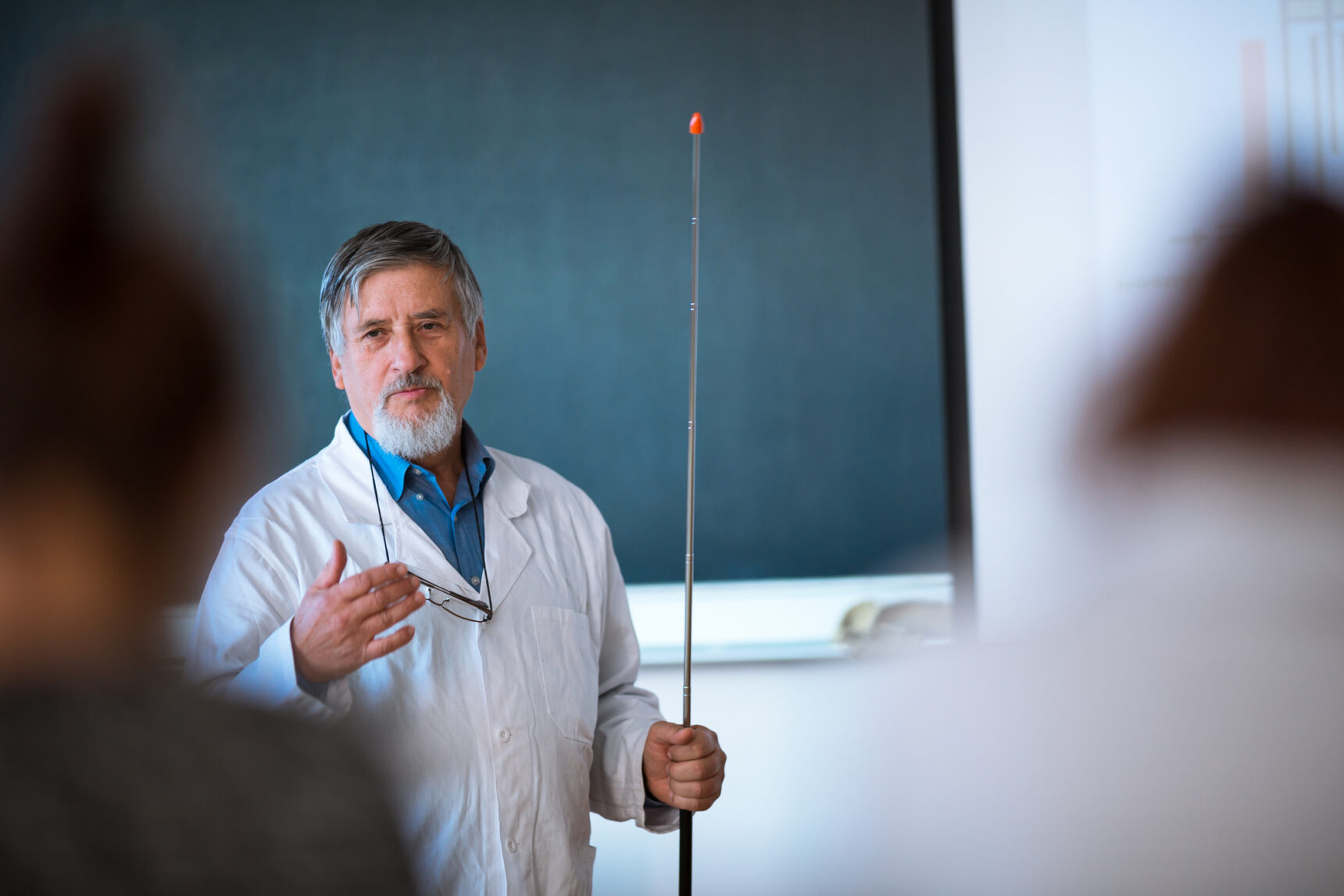 Senior Chemistry professor giving lecture to STEM students.