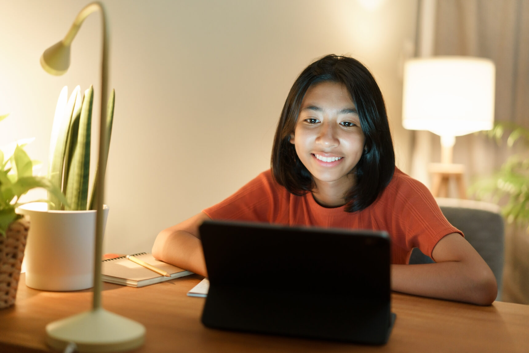 Young girl smiling during online tutoring session. Positive student-tutor relationship.