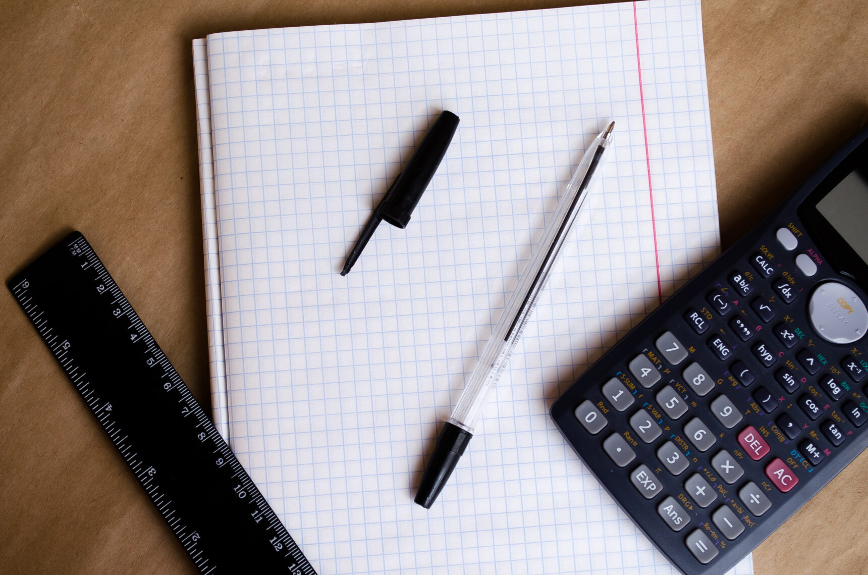 Calculator, ruler, pen, and notebook.