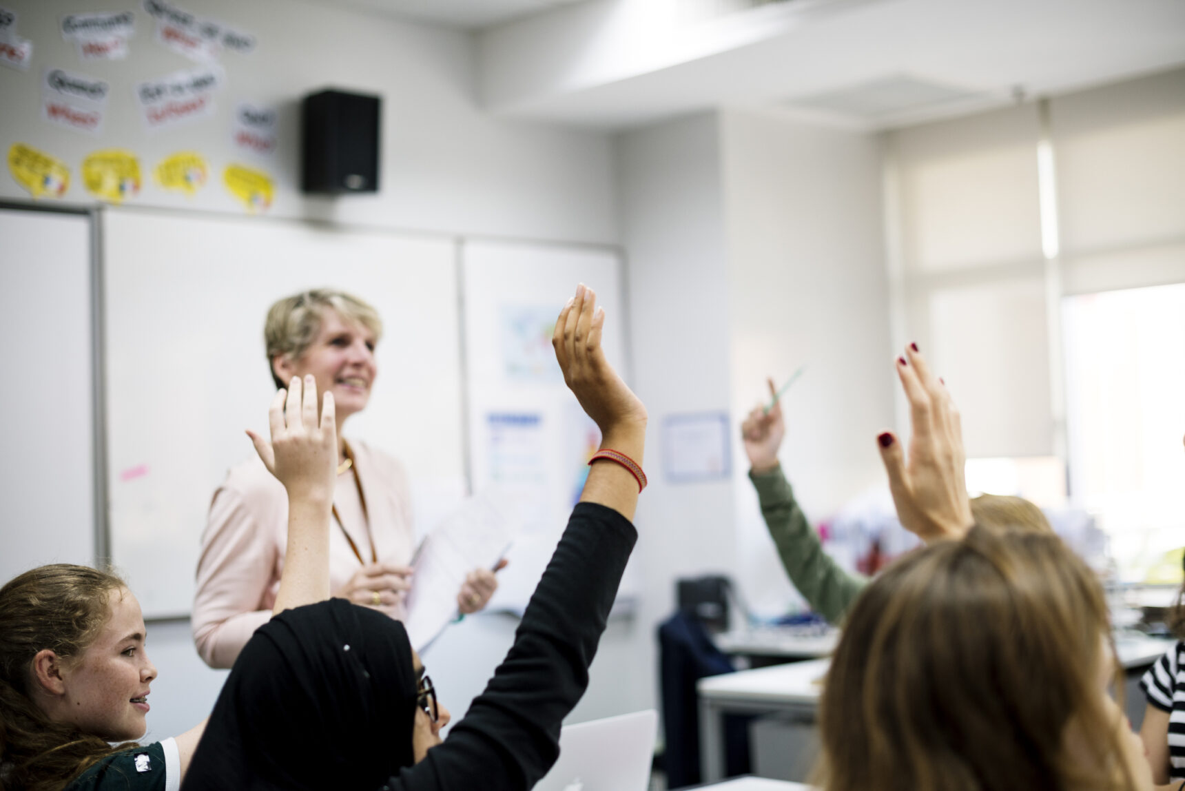 Hands up in classroom.