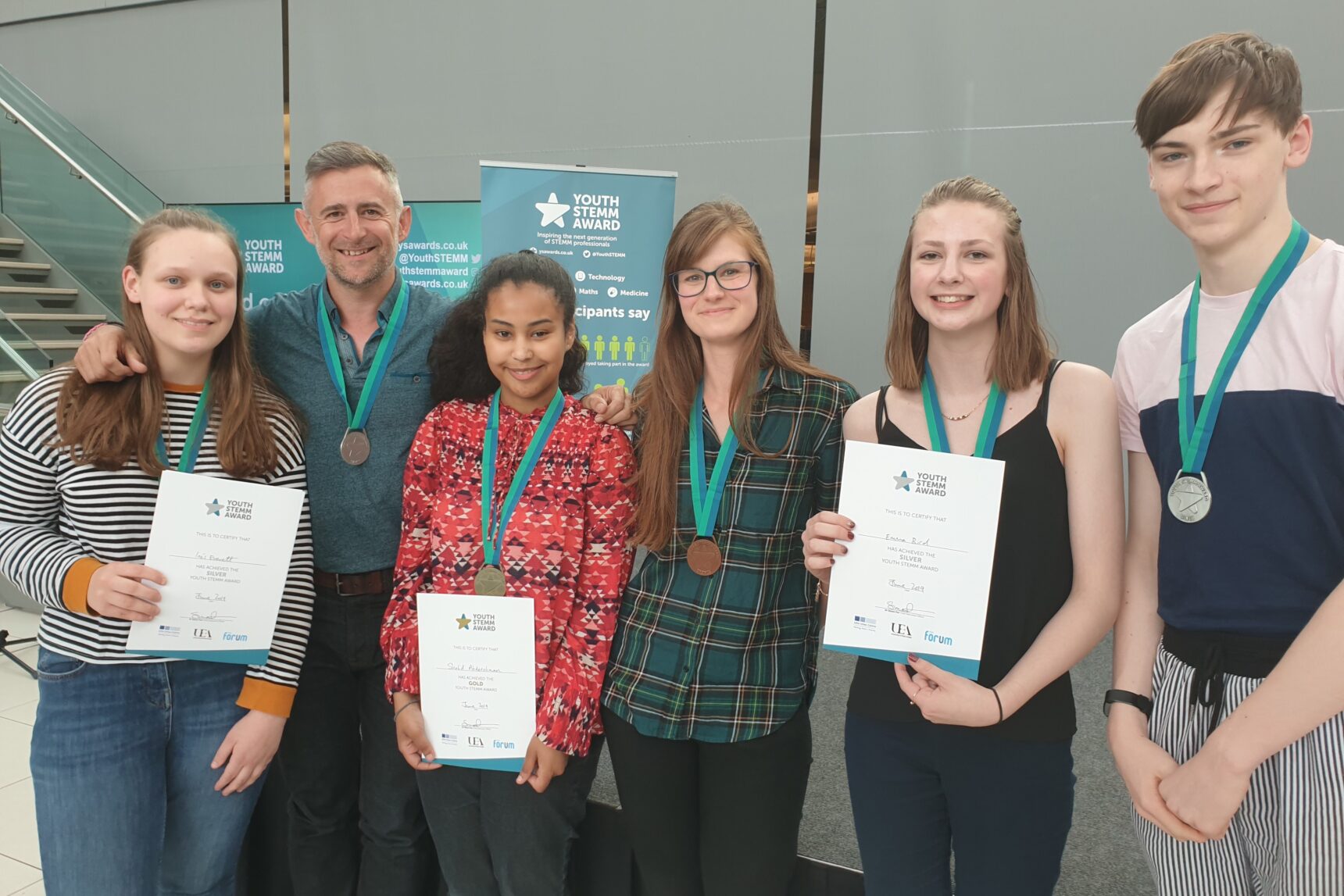 A group of award completers at The Forum in Norwich at an end of Year celebration event with YSA patron Mark Thompson and Michelle Reeve (Science Communicator).