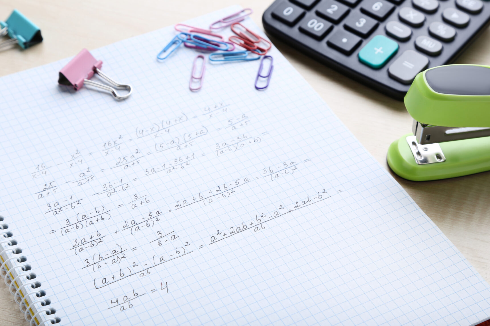 A Level maths notebook and calculator.