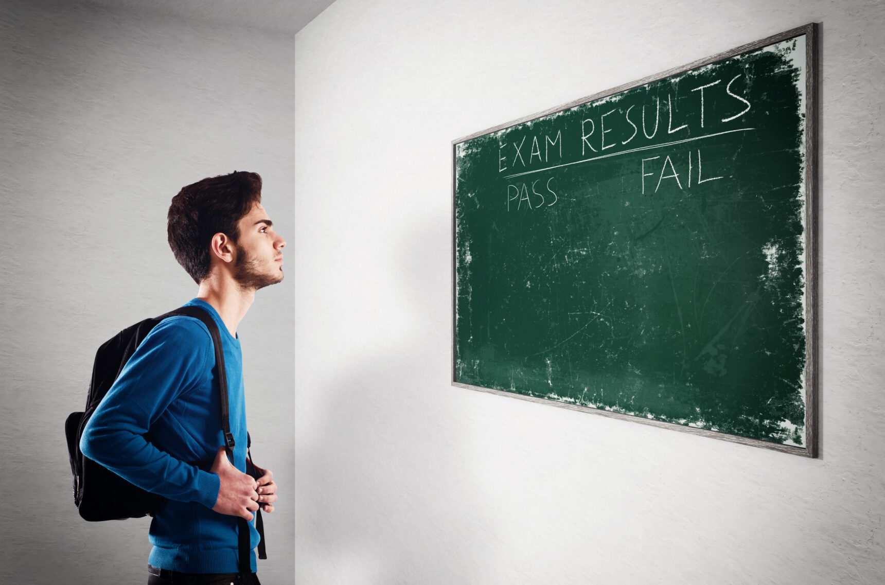 student looking at blackboard with exam results